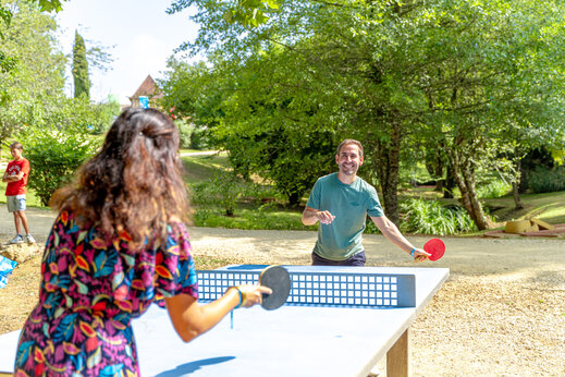 Table tennis players on an outdoor table at CAPFUN Moulinal campsite in BIRON (24).