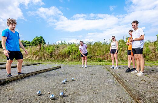 Petanque court and players at VAGUES OCEANES Moulin de Cadillac campsite (56).