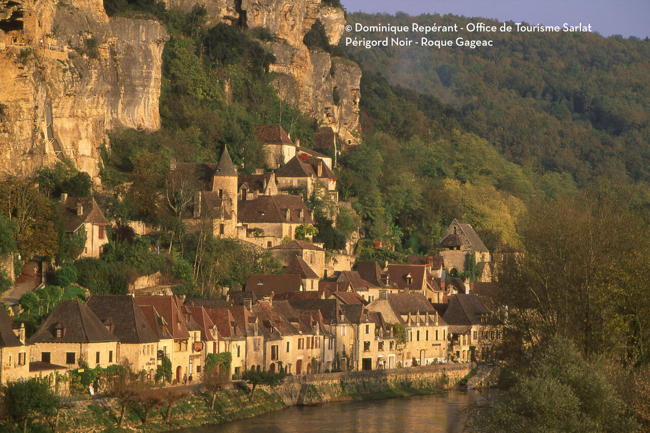 Village of La Roque-Gageac in Dordogne, troglodyte houses by the river.