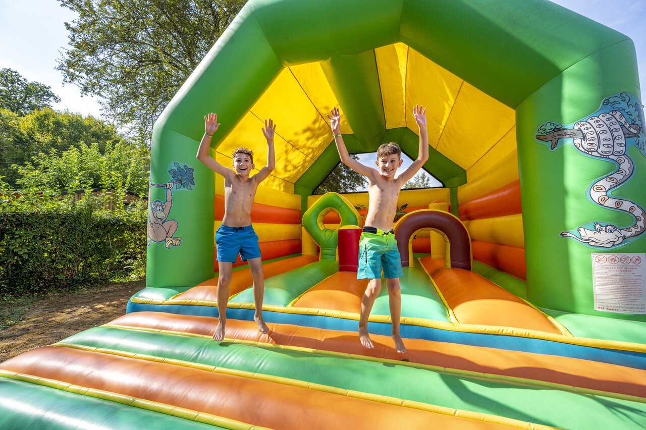 Bouncy castle, happy children at CLICOCHIC Moulin du Roch campsite in Saint Andre D'Allas (24).