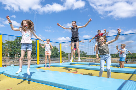 Children having fun on trampolines at VAGUES OCEANES Moustoir campsite in Carnac.