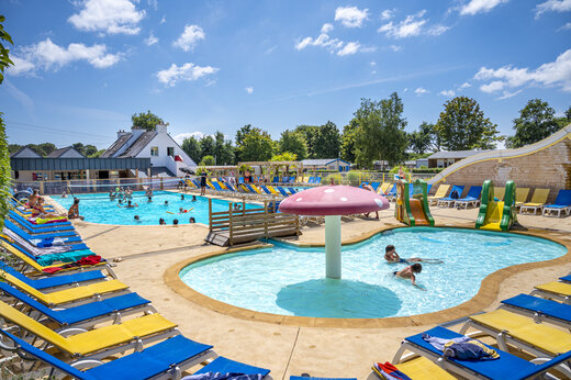 Outdoor pool, paddling pool and slides at VAGUES OCEANES Moustoir campsite Carnac.