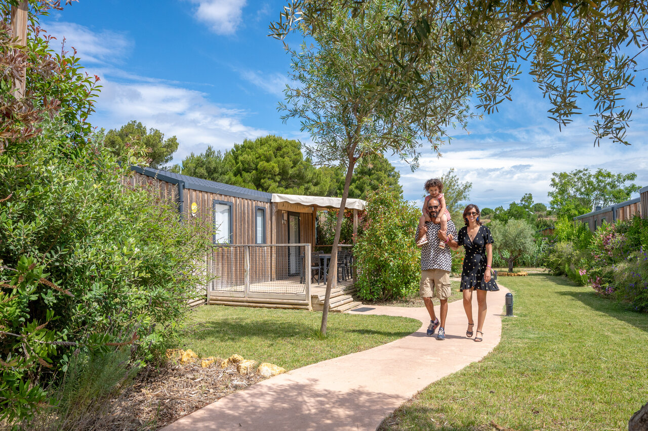 Family by modern Mobil-home, green surroundings, CAPFUN La Nautique campsite Narbonne (11).