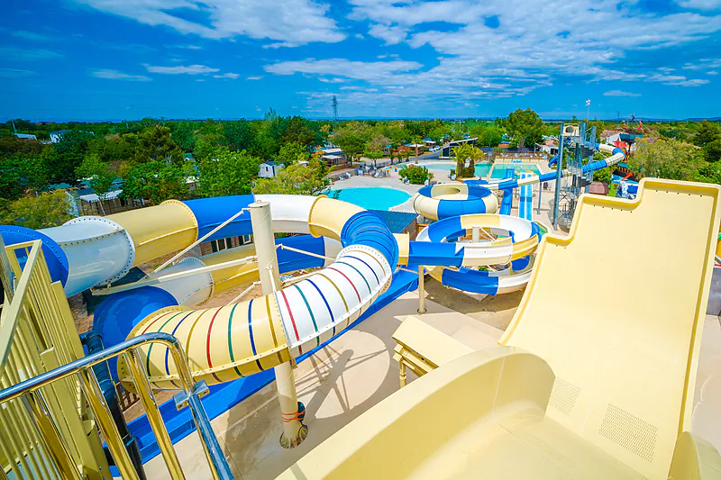 Large colorful water slides and swimming pools at CAPFUN La Nina campsite in Agde (34).