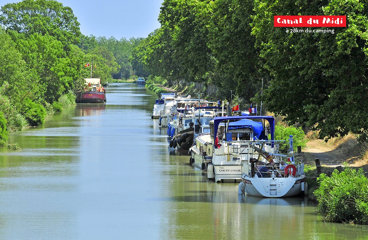 Canal du Midi with moored barges, a place to visit near Agde.