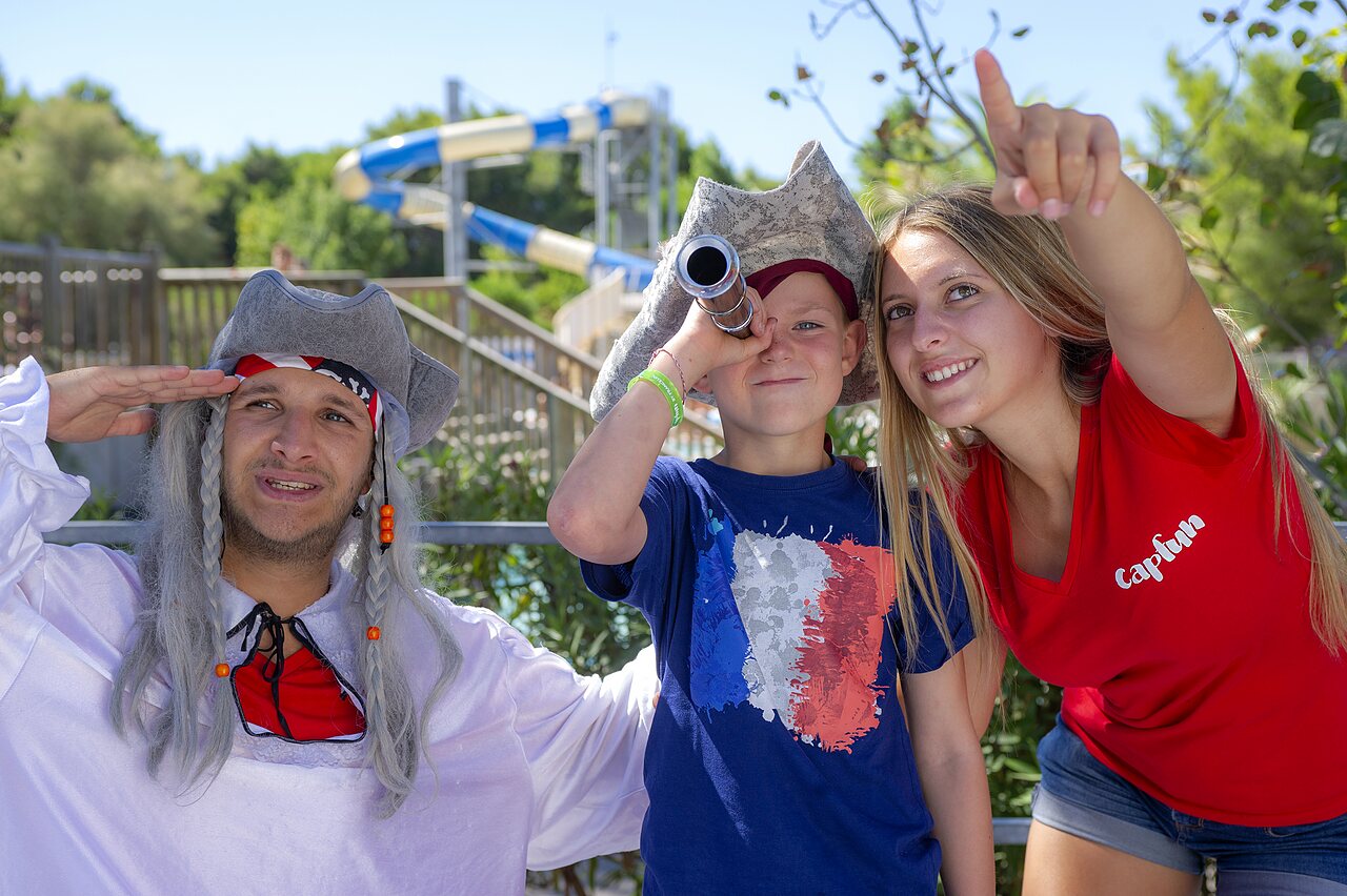 Animators dressed as pirates with child, water slides at CAPFUN La Nina campsite in Agde (34).