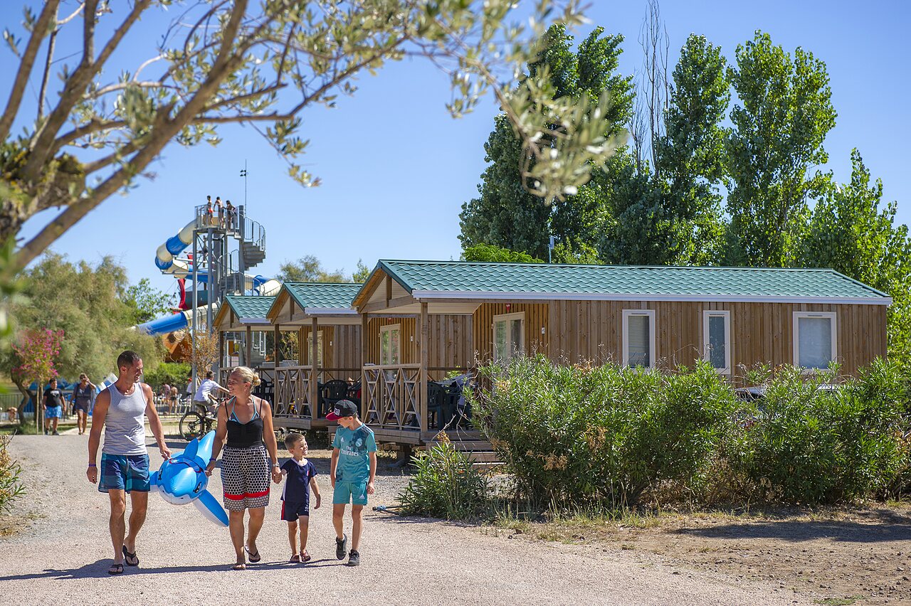 Mobile homes and water slide with family at CAPFUN La Nina campsite in Agde (34).
