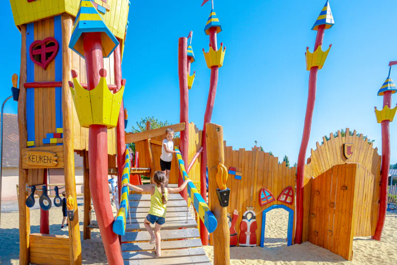 Wooden castle playground for children at VAGUES OCEANES Odyss�e campsite.