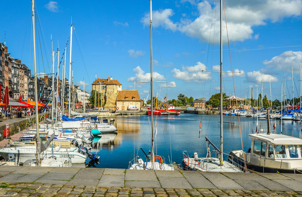 Lively marina, boats and historic buildings at VAGUES OCEANES Odyss�e campsite.