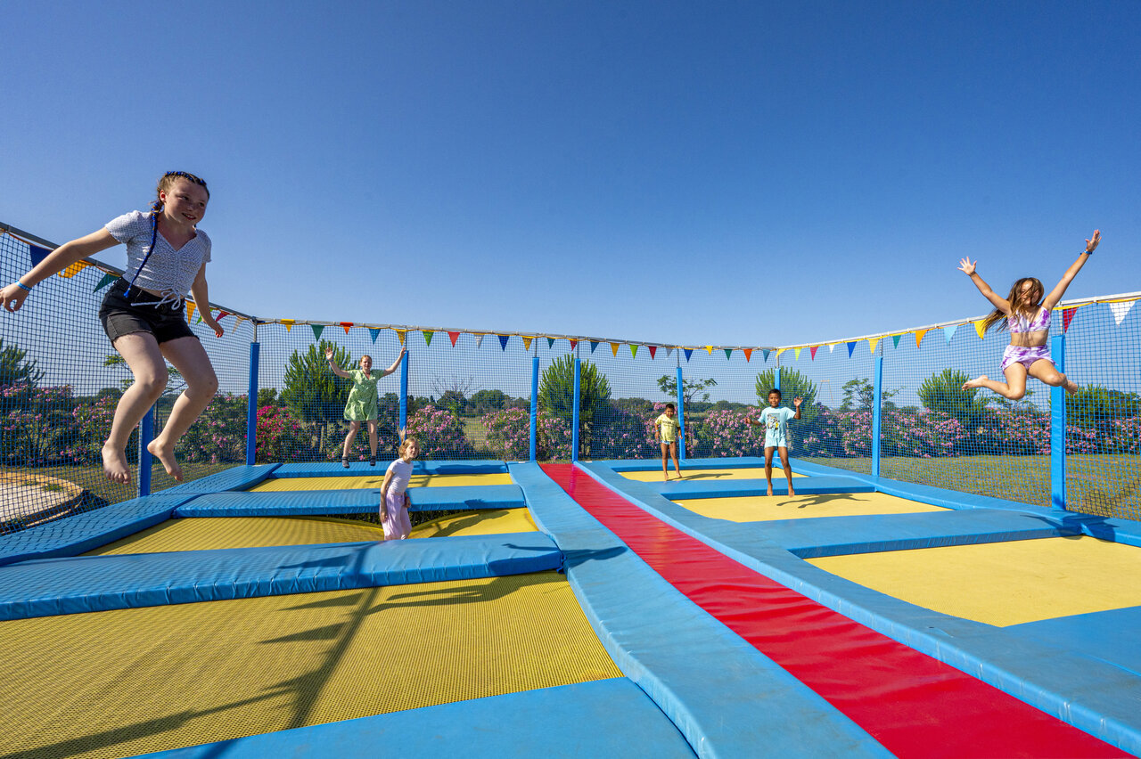 Children enjoying trampolines at CAPFUN Ondines campsite in Vias Plage (34).
