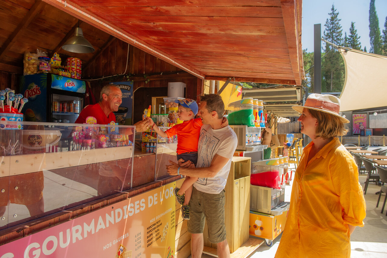 Child receives ice cream at CAPFUN Or campsite in La Grande Motte (34).