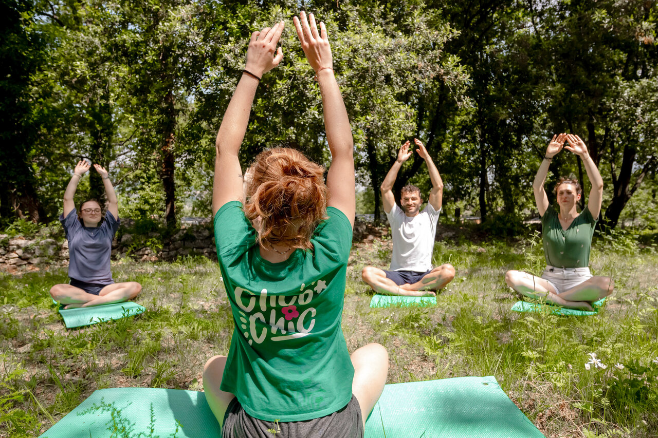 Adults enjoying outdoor yoga at CLICOCHIC Or�e d'Azur campsite OPIO (06).