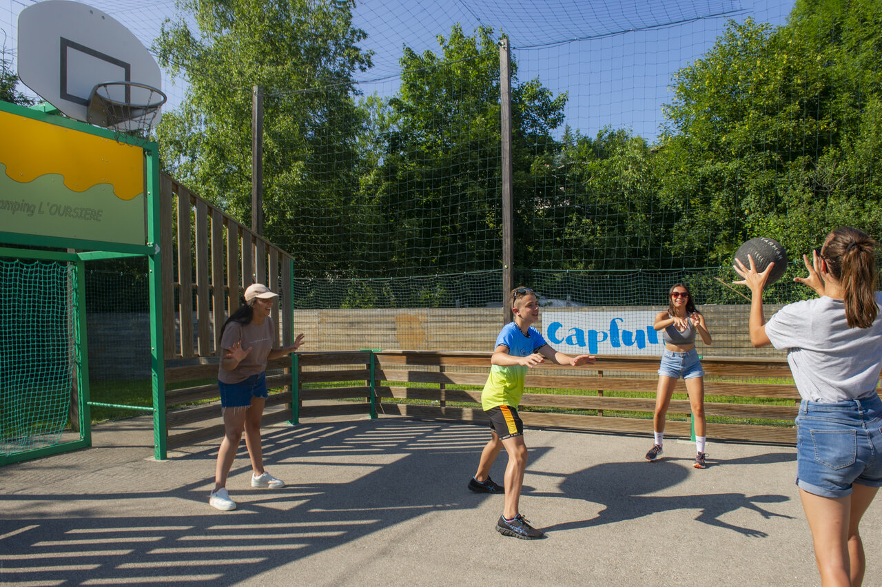 Young people playing ball on multi-sport court at CAPFUN Oursi�re campsite in Villard de Lans (38).