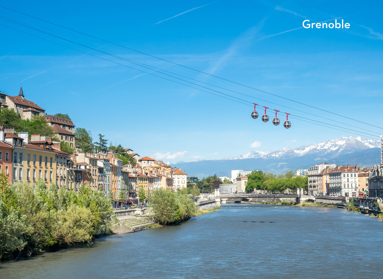 Bastille cable car over Is�re river, historic buildings, snowy mountains in Grenoble.