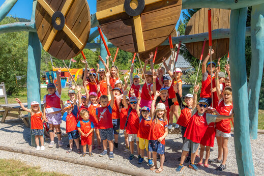 Smiling children playing on a wooden structure at CAPFUN Oursi�re campsite in Villard de Lans (38).