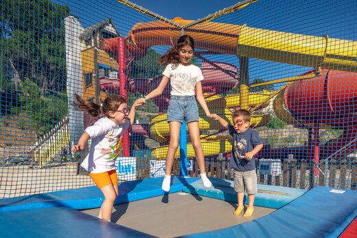Children on trampoline, water slides at CAPFUN Pachacaid campsite in La Mole (83).
