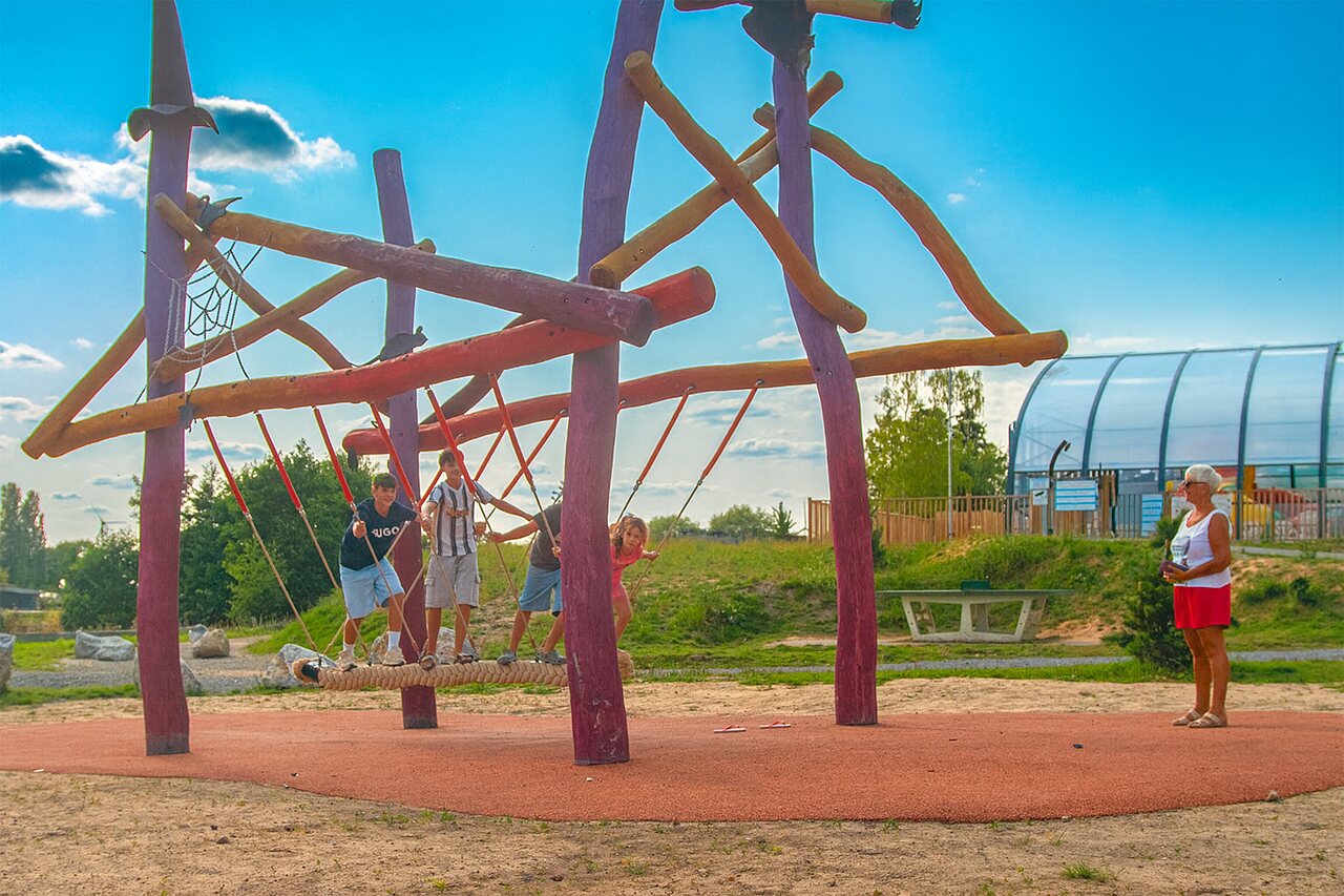 Wooden playground, covered pool at CAPFUN Pachy campsite FOSSES LA VILLE.