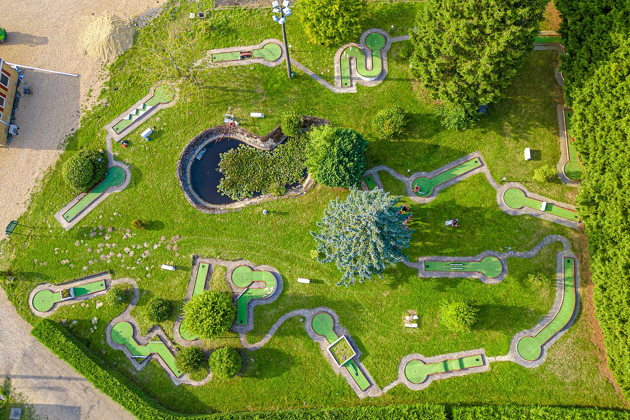 Mini-golf course with pond at CAPFUN Pachy campsite in FOSSES LA VILLE