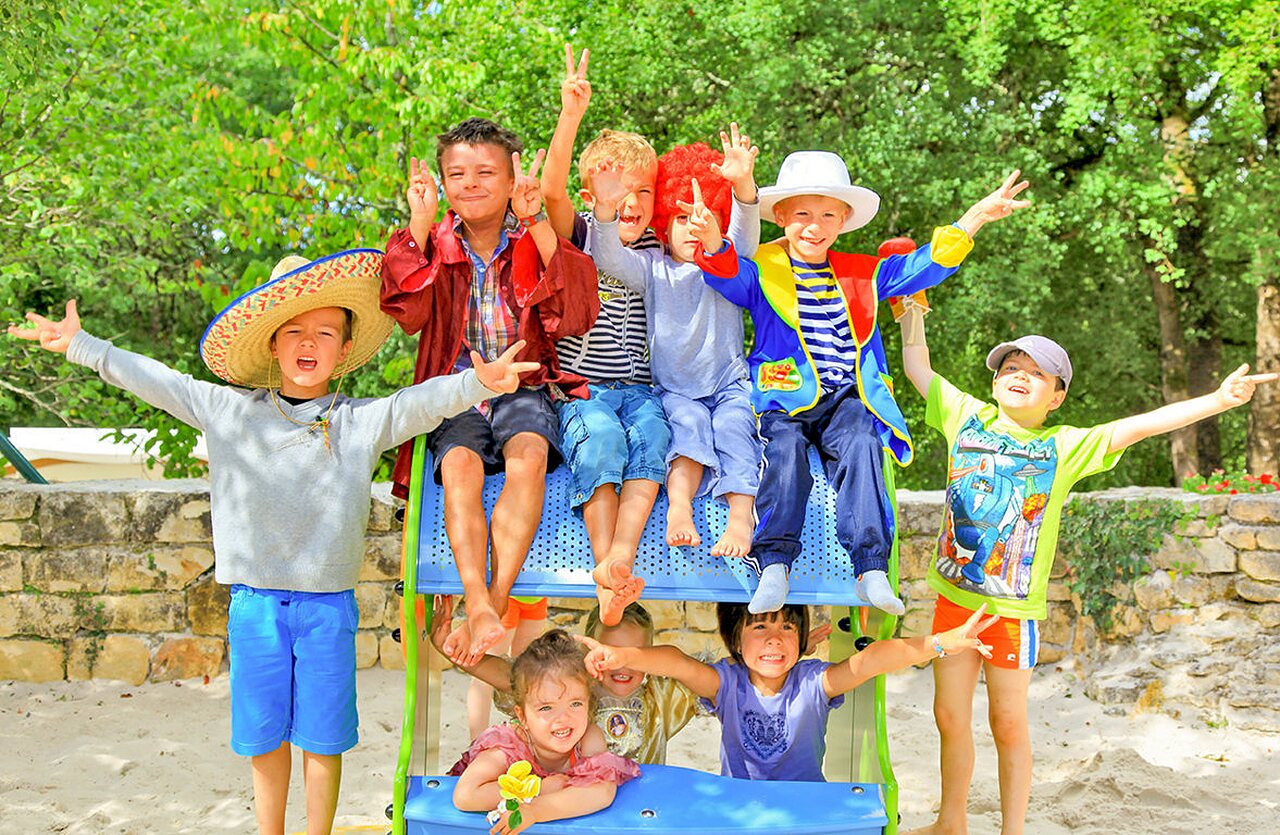 Costumed children on playground camping VAGUES OCEANES Paille Basse Souillac (46).