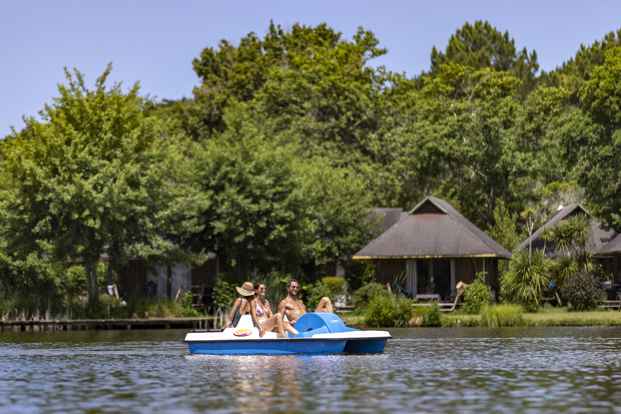 Pedal boat on the lake, lush nature at CAPFUN Paillotte campsite AZUR (40).