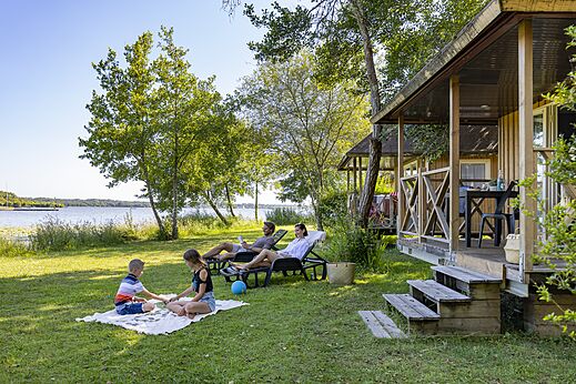 Family by Mobile-home and lake, CAPFUN Paillotte campsite in AZUR (40).