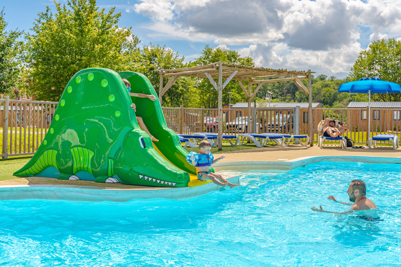 Swimming pool, crocodile slide, children at CAPFUN Palais de Gaufrette campsite in R�mering les Puttelange (57).
