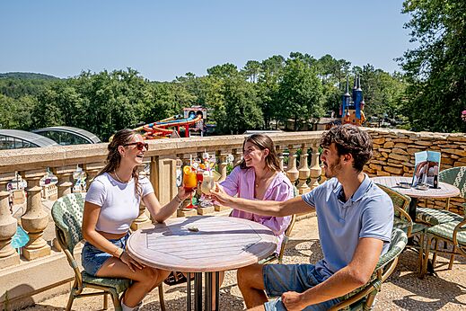 Friends toasting cocktails on terrace at CAPFUN Palombi�re in SAINT-NATHALENE (24).