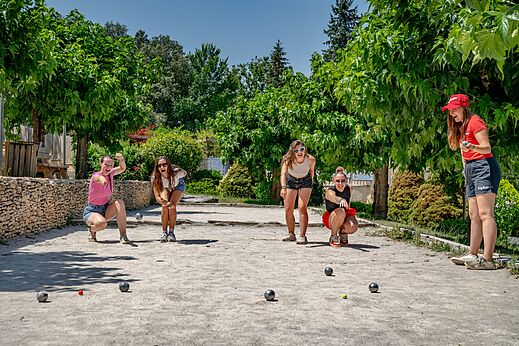 Young women playing p�tanque at CAPFUN Palombi�re campsite in SAINT-NATHALENE.