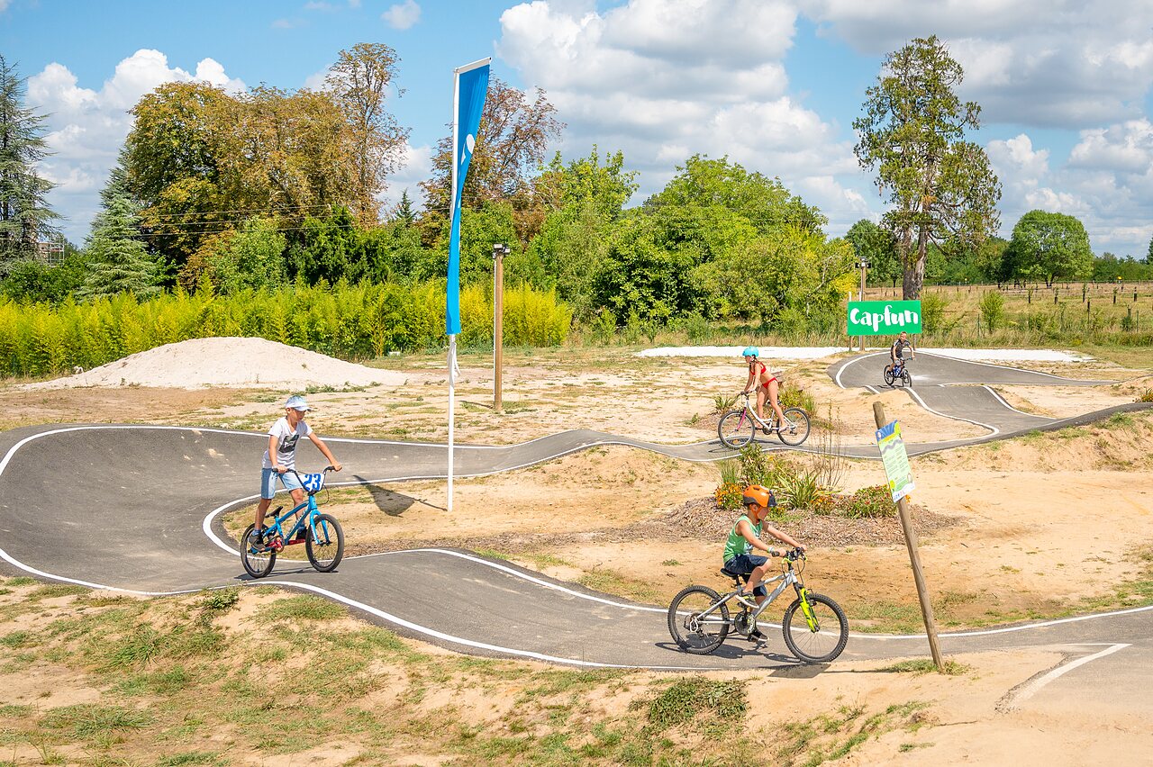 Pumptrack and children cycling at CAPFUN Paradis de Bazas campsite in BAZAS (33).