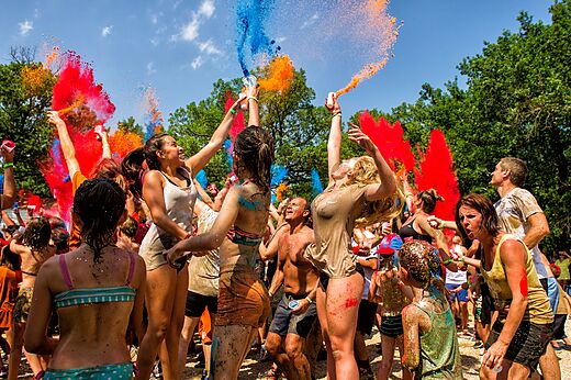 Colorful Holi powder party with happy participants at CAPFUN Paradis de Bazas campsite in BAZAS (33).