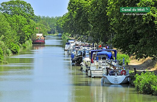 Canal du Midi with moored boats, a place to visit near Marseillan-Plage.