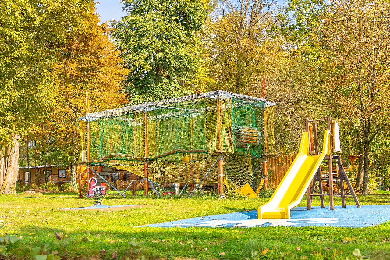 Yellow slide, net play structure at CAPFUN Parc de Paris campsite in Villevaud�.