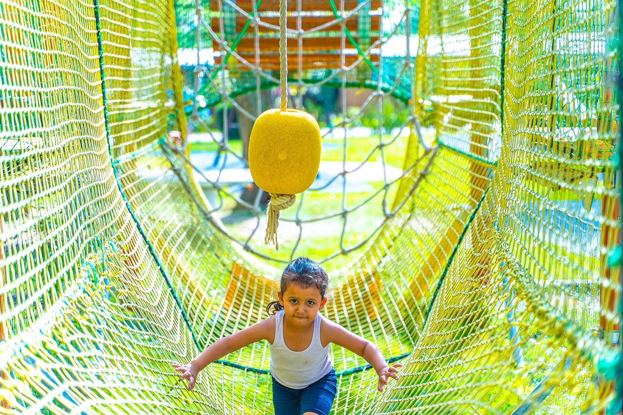Child in net play tunnel at CAPFUN Parc de Paris campsite in Villevaud� (77).