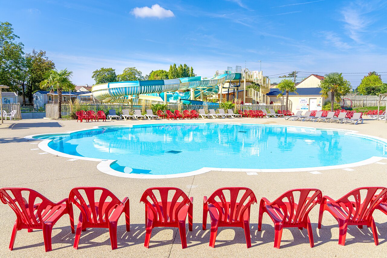 Outdoor pool, slides, loungers at CAPFUN Parc de Paris campsite in Villevaud� (77).