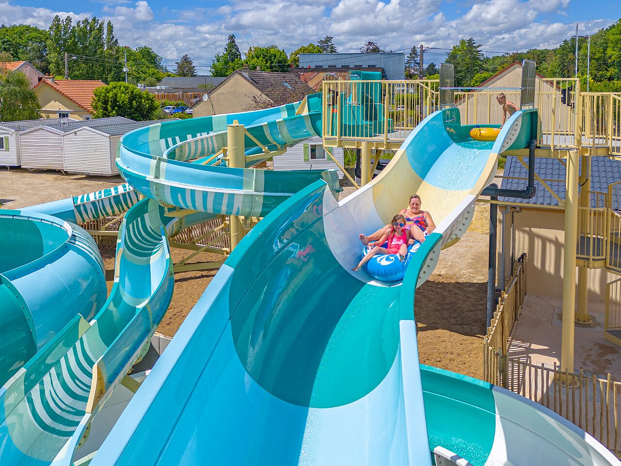 Giant water slides and children having fun at CAPFUN Parc de Paris (77).