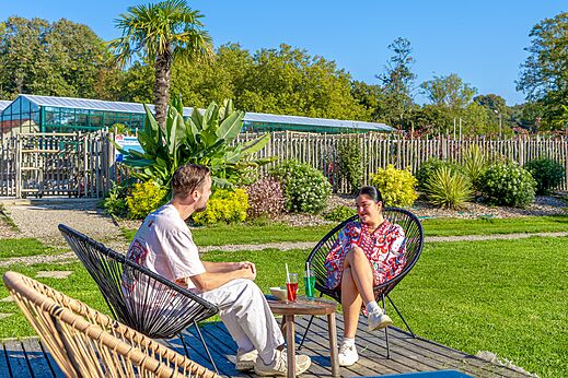 Relaxed couple drinks at CAPFUN Parc de Paris campsite in Villevaud� (77).