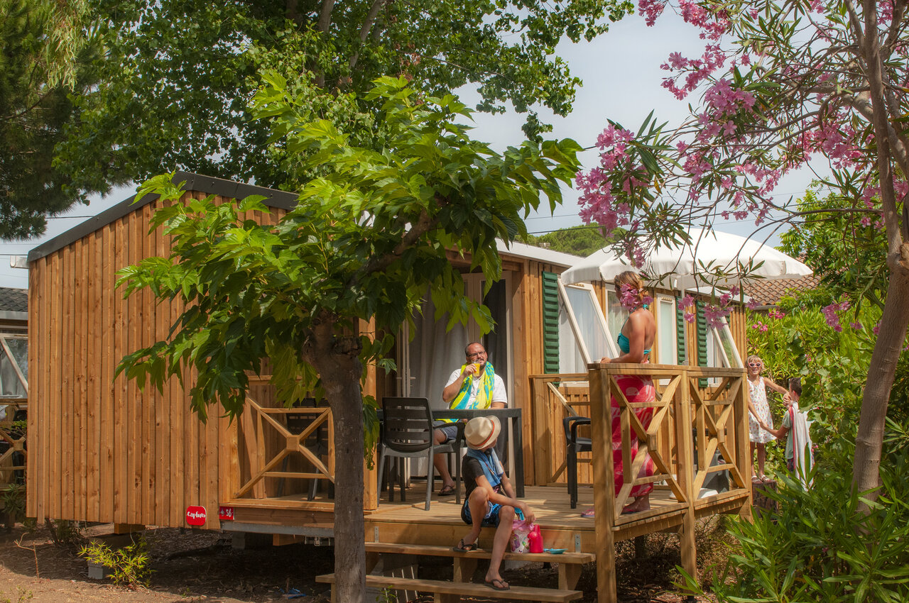 Mobile home with wooden terrace and family at CAPFUN Parc et Plage Hy�res.