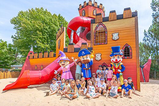 Castle playground, slides, children and CAPFUN mascots in CAZAUX (33).