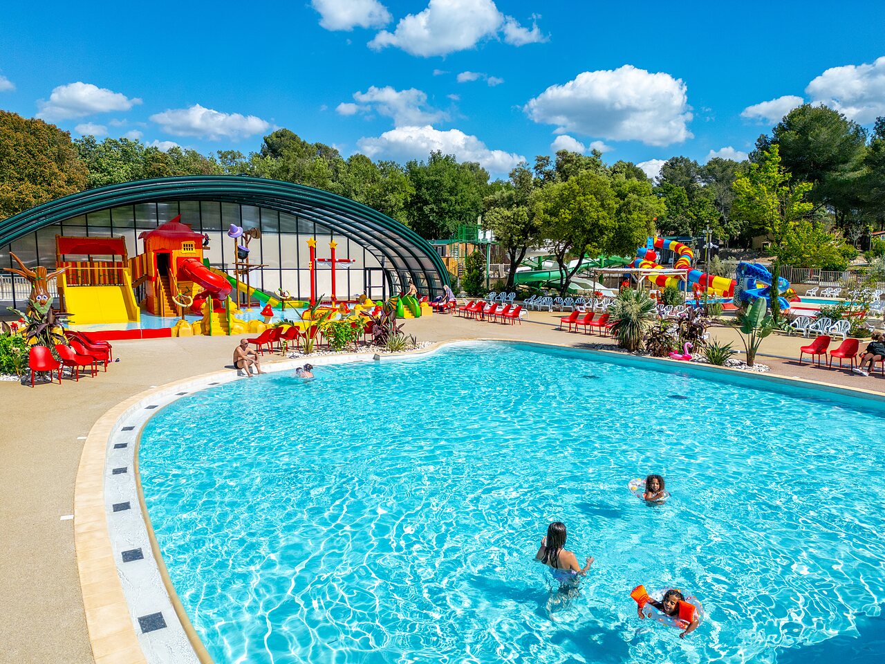 Outdoor pool, slides and water games at CAPFUN Pin�des du Luberon campsite.