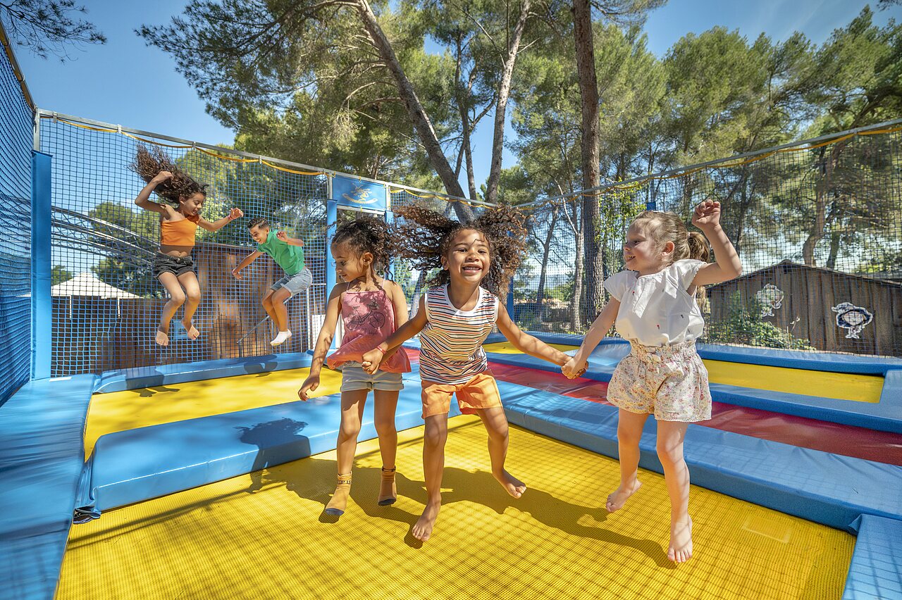Children play on safe trampolines at CAPFUN Pin�des du Luberon campsite in PERTUIS.
