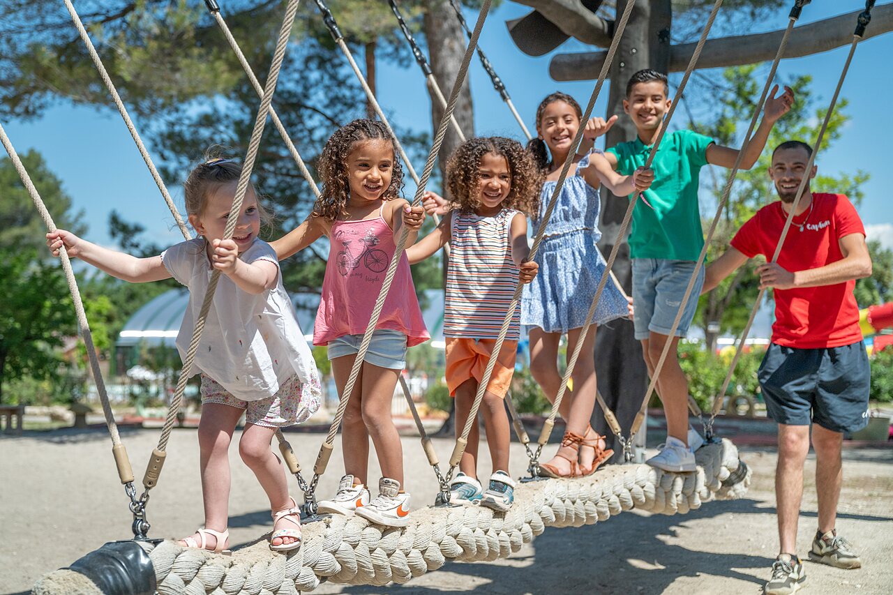 Children and animator on rope bridge playground, CAPFUN Pin�des du Luberon, PERTUIS (84).