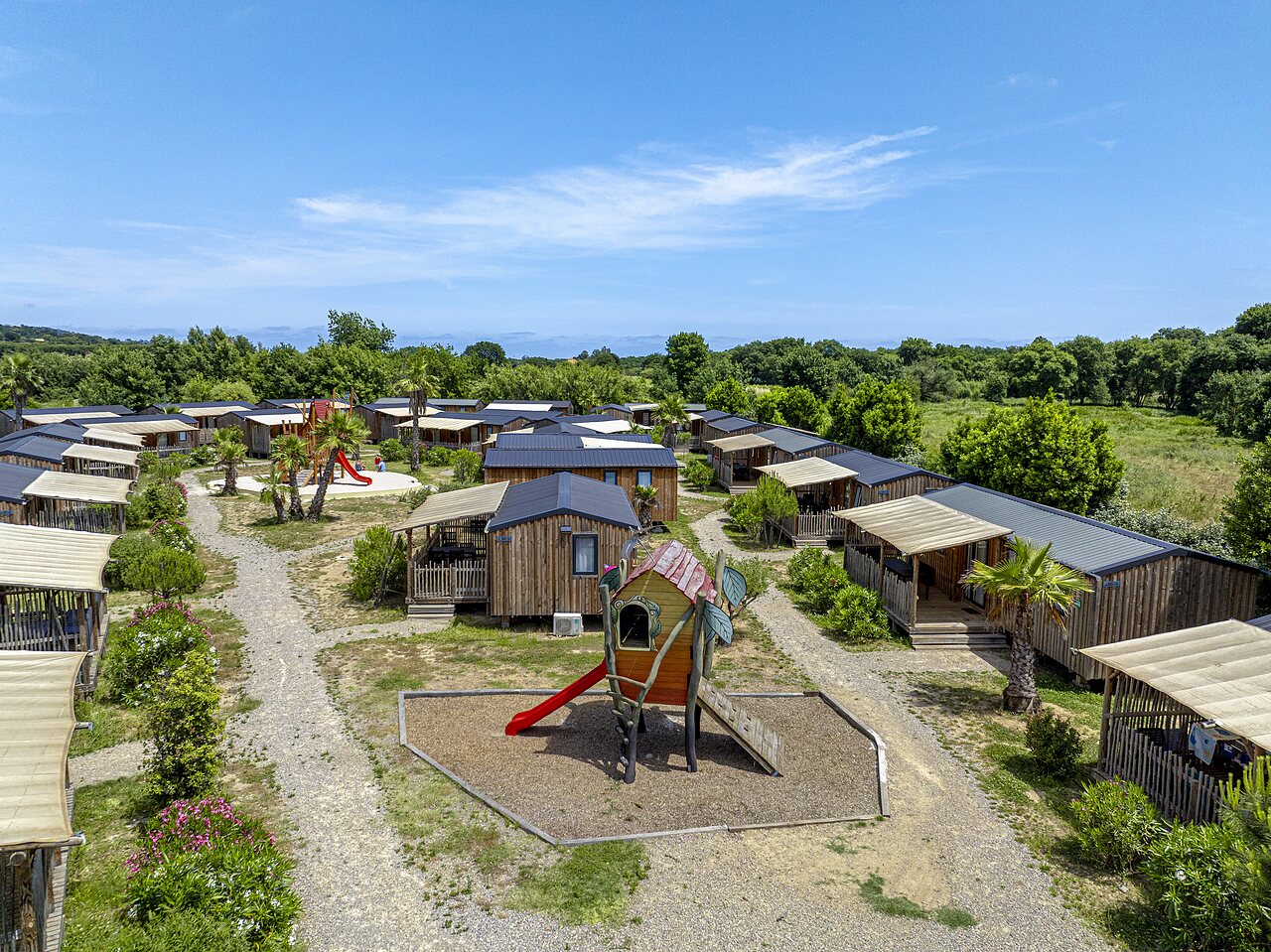 Wooden Mobile homes and children's play areas at CAPFUN La Pin�de de Grimaud campsite in Grimaud (83).