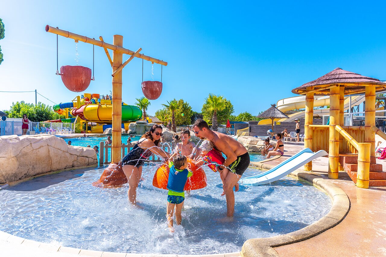 Family in water play area at CAPFUN La Pin�de de Grimaud campsite.