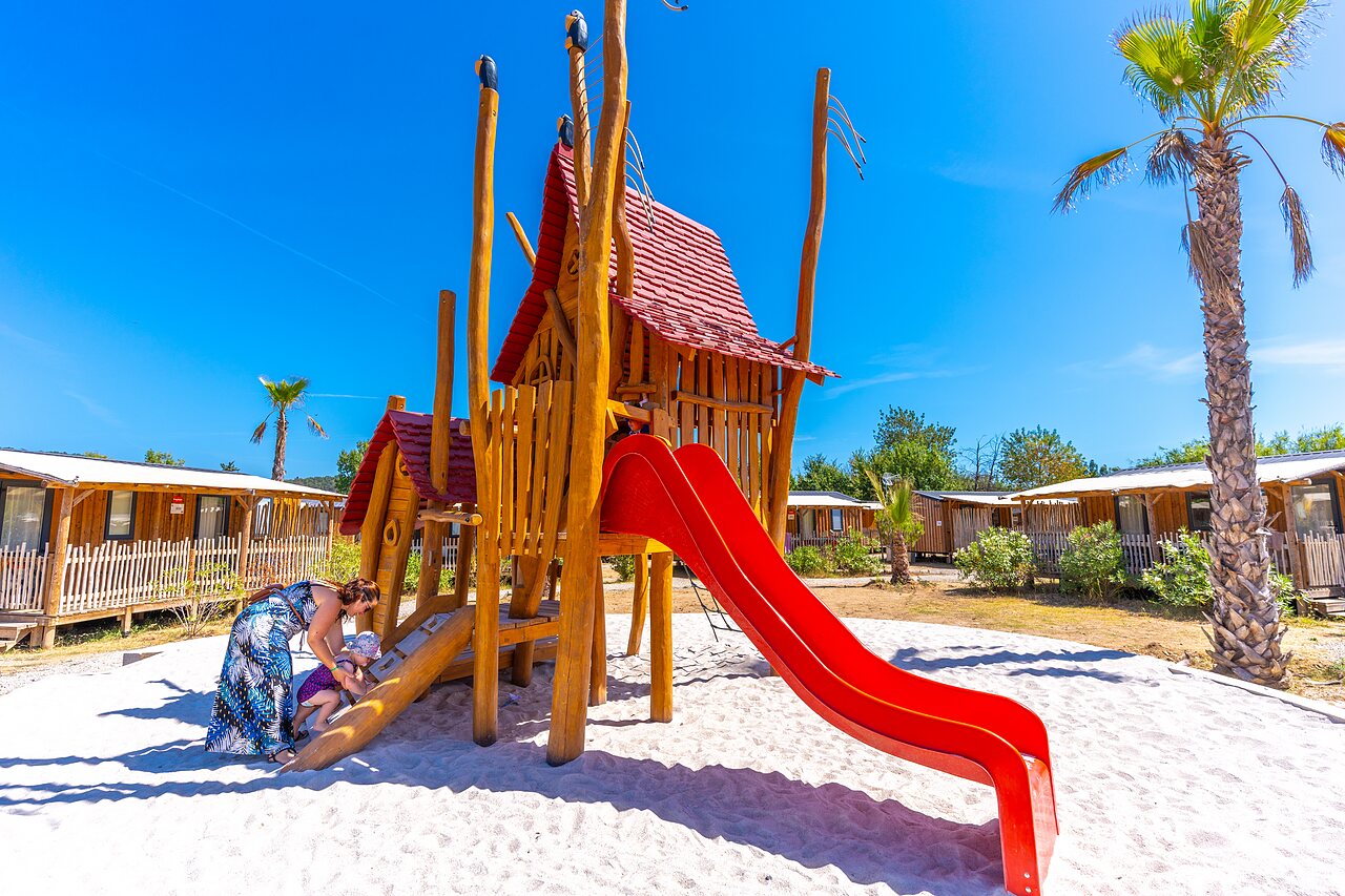 Playground, slide, Mobile homes at CAPFUN La Pin�de de Grimaud campsite.