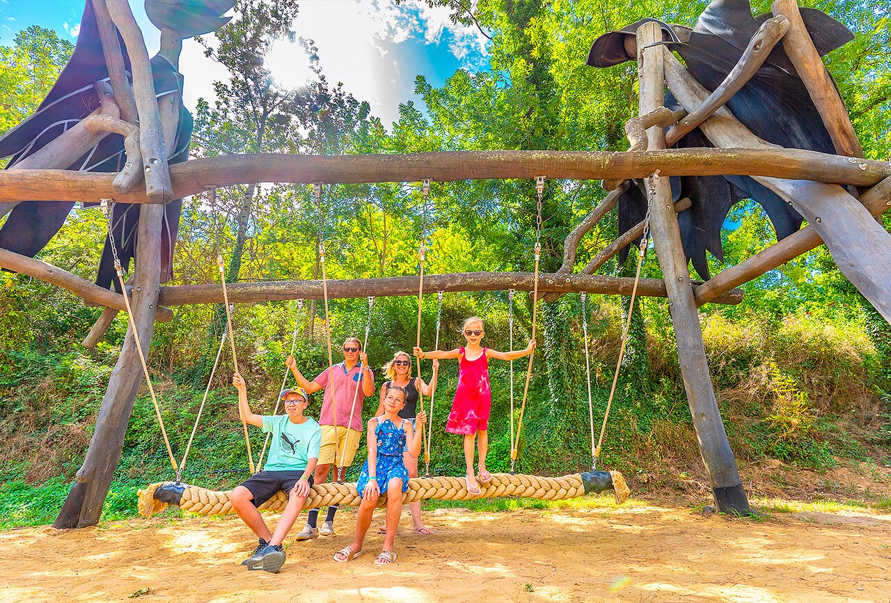 Family having fun on giant swing at CAPFUN Plantas campsite, SAINT VINCENT DE DURFORT.