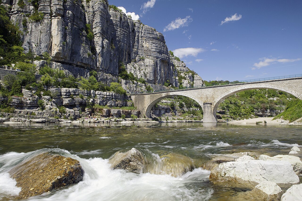 Stone bridge, river and cliffs at CAPFUN Plantas campsite in SAINT VINCENT DE DURFORT.