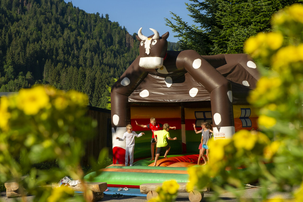 Inflatable cow bouncy castle for kids at CAPFUN Plan du Fernuy, LA CLUSAZ.