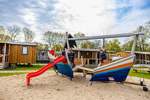Boat-shaped playground with slide for children at CAPFUN Ponderosa campsite in Ulicoten.