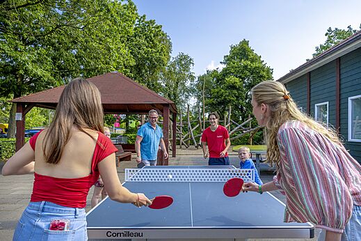 Family playing table tennis on Cornilleau table at CAPFUN Ponderosa in Ulicoten.