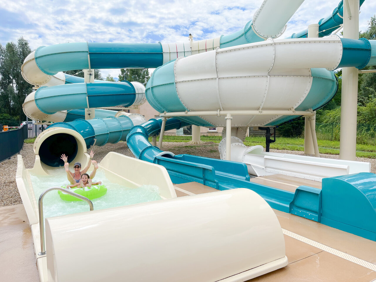 Water slide, children at CAPFUN Les Portes du Beaujolais campsite in Anse (69).